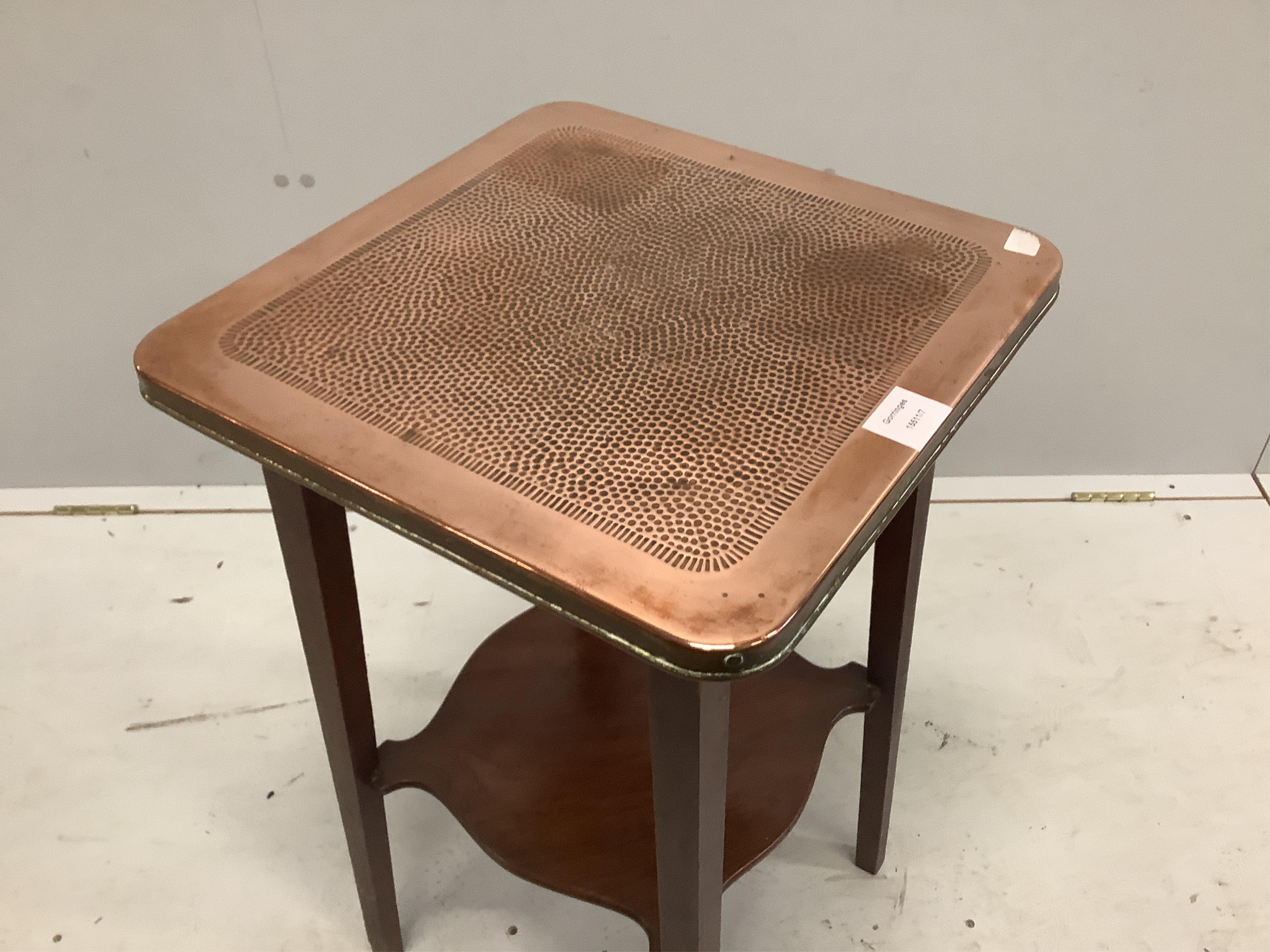 An early 20th century mahogany two tier table with hammered copper top, width 40cm, depth 40cm, height 69cm. Condition - fair to good